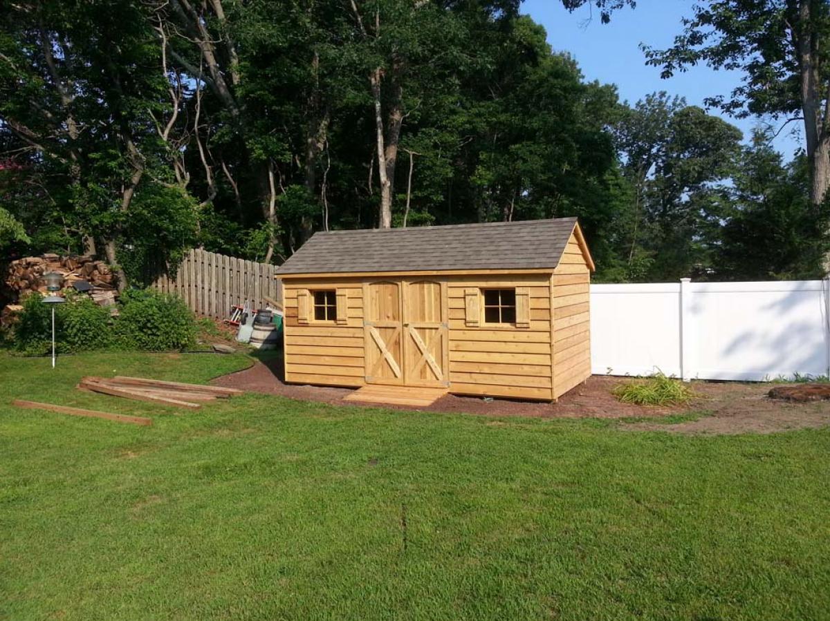 8x16 cedar gable, double 30 inch doors, 2 windows with shutters, 60 inch ramp, weathered wood roof