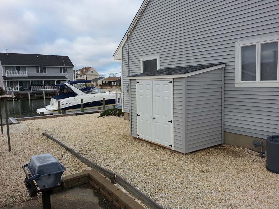 5x7 "lean-to" gray vinyl siding, double 30 inch 6-panel doors, no windows, pewter gray roof