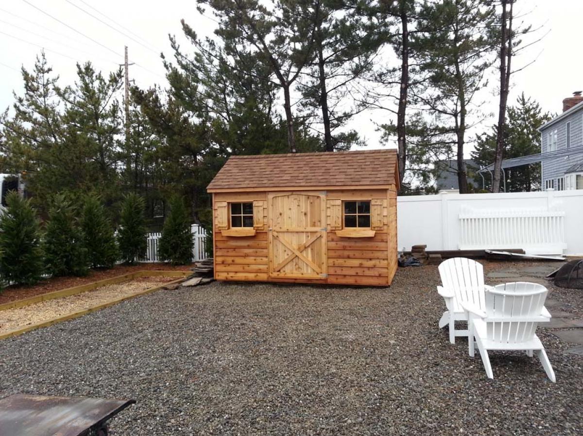 8x12 cedar gable, 48 inch door, 2 windows with shutters, 2 window boxes, shakewood roof