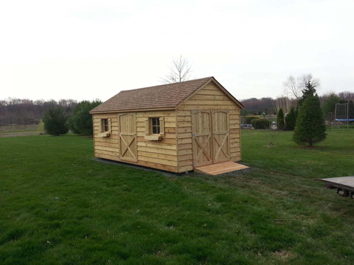 10x16 cedar gable, 48 inch door on front, double 30 inch doors on side, 60 inch ramp, 2 windows with shutters, 2 window boxes