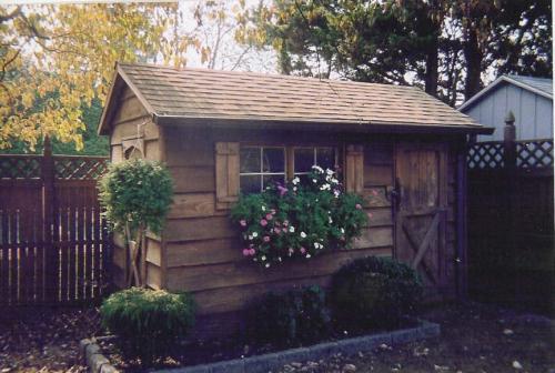 15 year-old 6x12 Cedar, 2 doors, 2 windows, shakewood roof