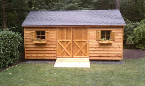 10x18 cedar gable, 2 36 inch door, 72 inch ramp, 2 windows with shutters and window boxes, black roof