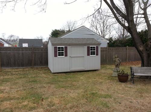 8x12 gray utility gable, 48 inch door, 2 windows, red shutters, weathered wood roof