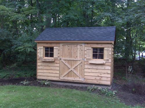 8x12 cedar gable, 48 inch door, 2 windows with shutters and window boxes, black roof