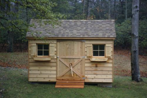 8x12 cedar gable, 48 inch door, 2 windows with shutters and window boxes, 48 inch ramp, shakewood roof