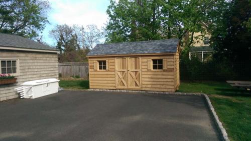 8x16 cedar gable, double 30 inch doors, 3 windows with shutters, pewter gray roof