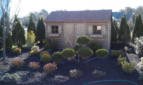 Slightly Weathered 8x14 Cedar Gable tucked into the landscaping